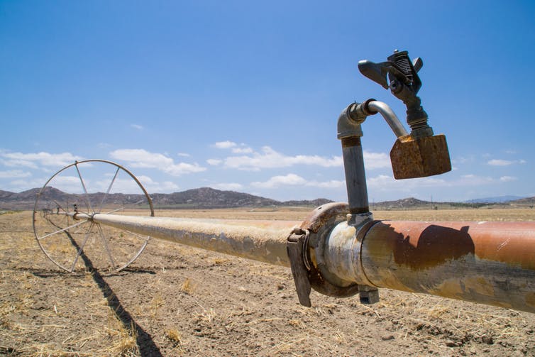 A water pipe across dry farmland