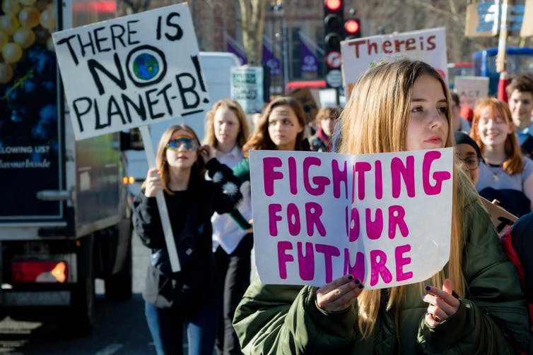 School students carrying posters calling for climate action