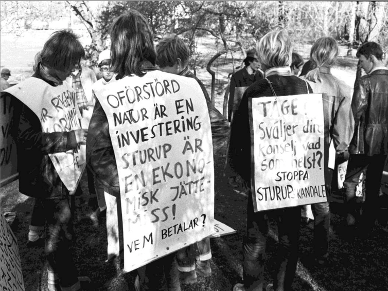 People wearing placards with anti-airport slogans