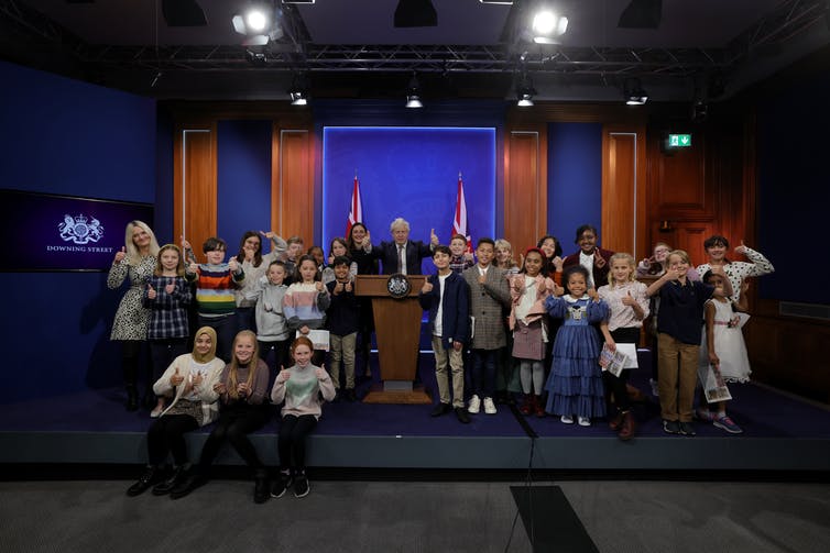 UK prime minister Boris Johnson is surrounded by children