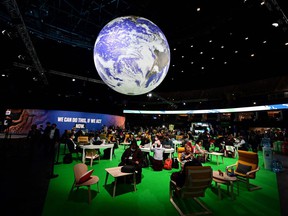 Delegates sit in the Action Zone as they attend the third day of the COP26 UN Climate Summit in Glasgow on Wednesday.