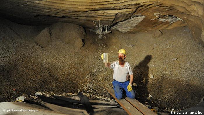 A worker takes a sample of dripping water in the Asse mine. (Photo: Jochen Lübke)