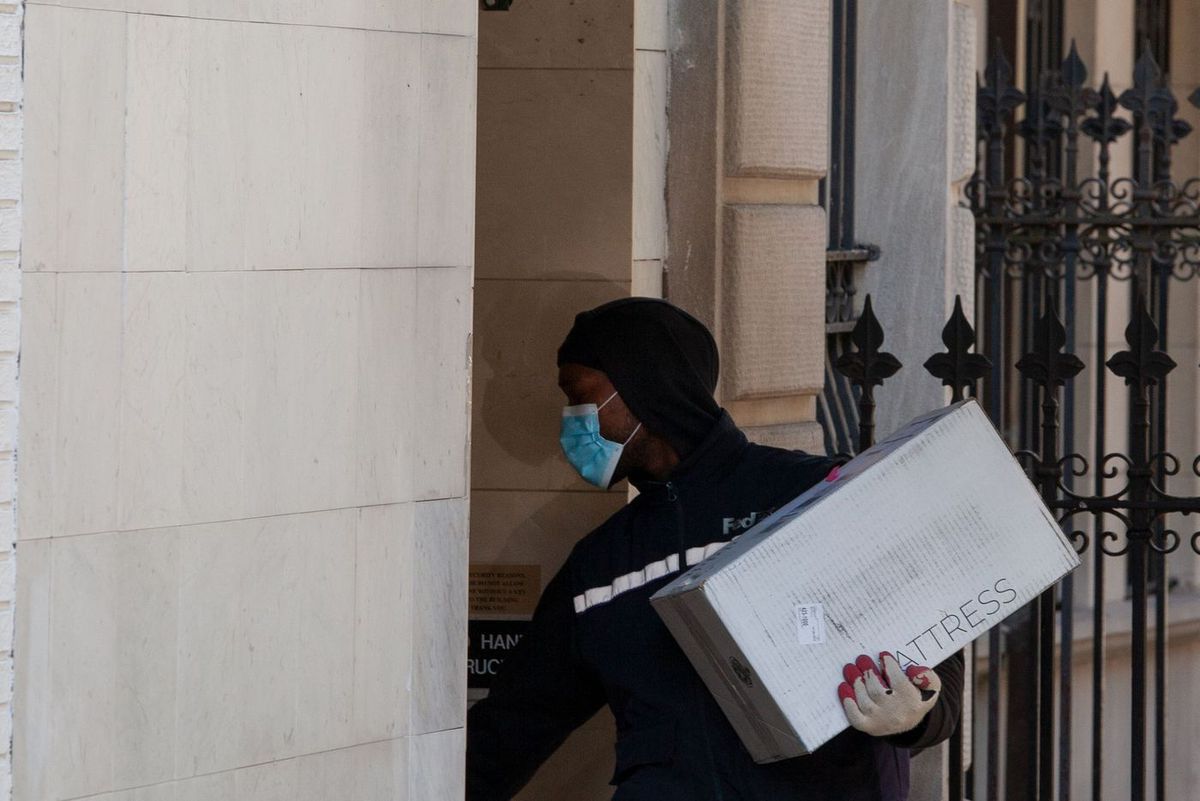 A FedEx worker delivers a package on the Upper East Side during the coronavirus outbreak.