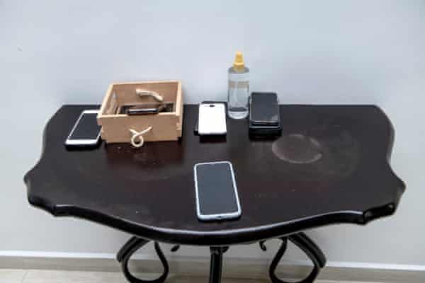 Phones left on a table outside the office.
