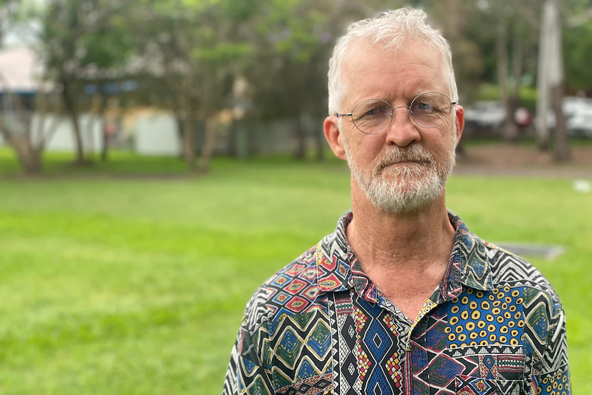 an older man in a grey shirt