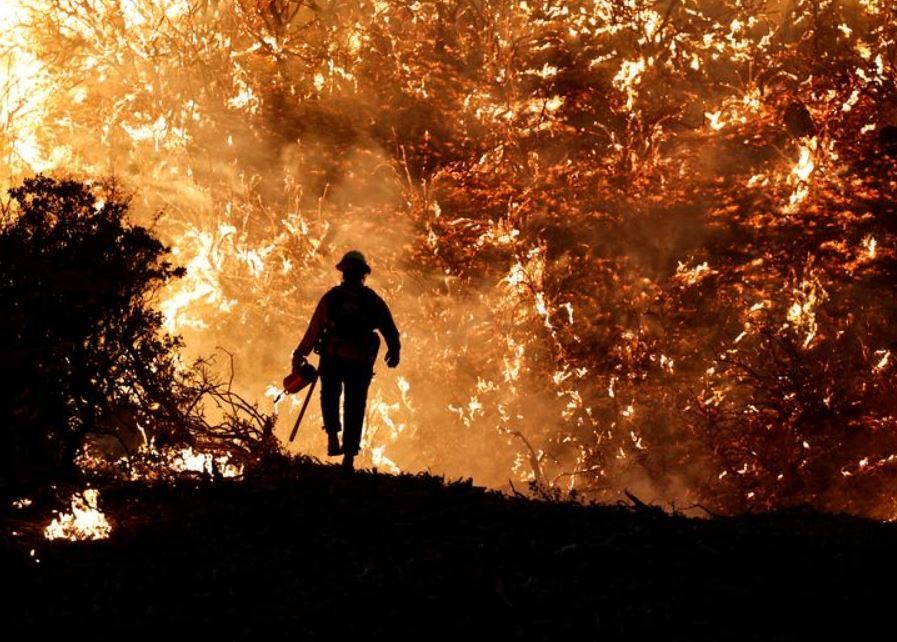 A firefighter tackles the Caldor Fire as it burns in Grizzly Flats, California, in August.