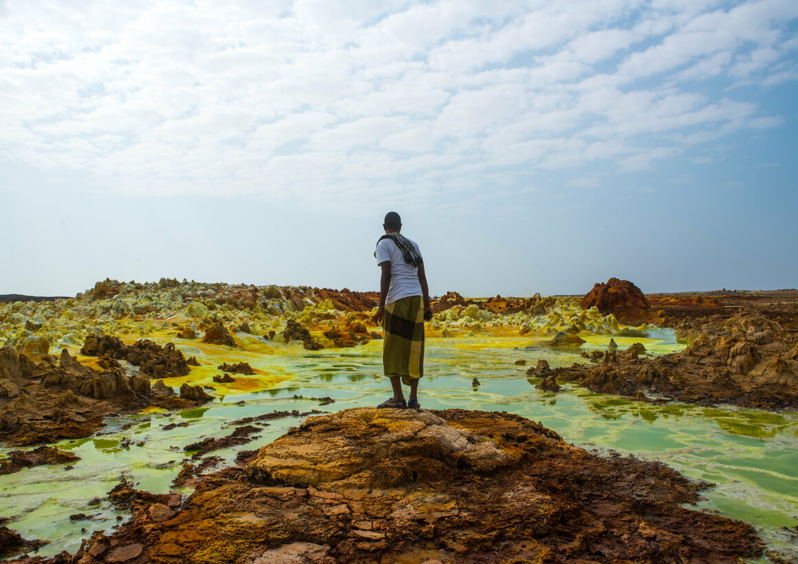 An Afar man looks out over toxic pools in the Danakil Depression.