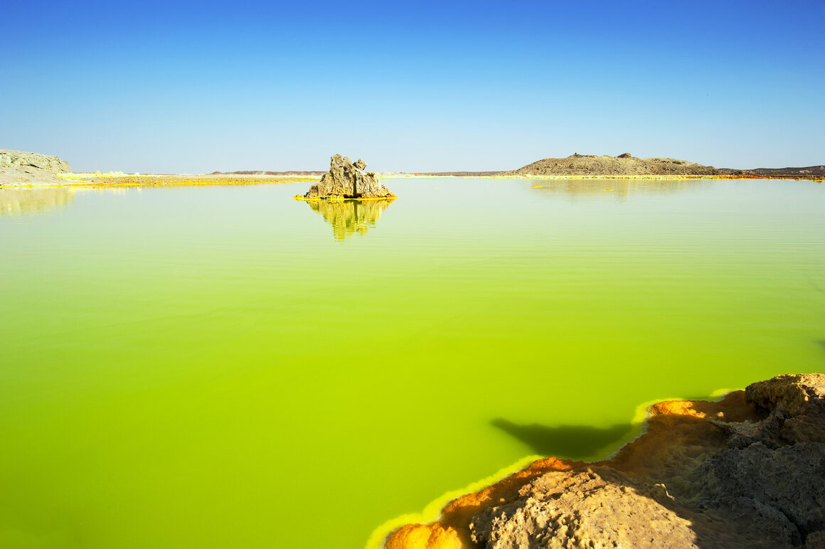 A water-filled eruption crater at Dallol.