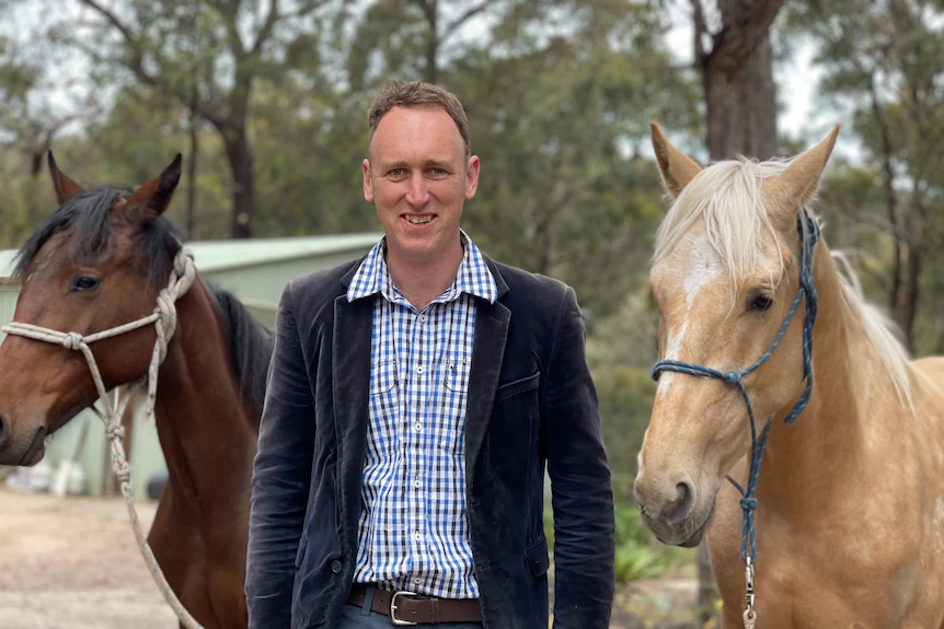 A vet with two of his horses