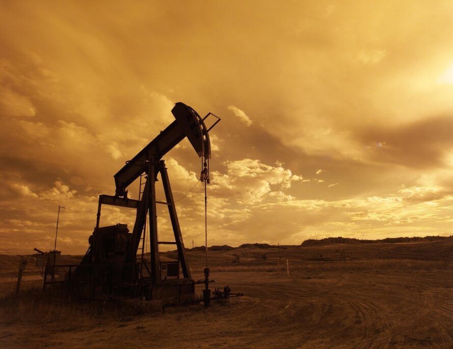 An oil pump in a desert with a yellow filter over the image