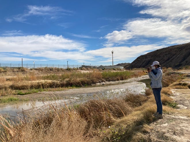 Raymundo Aguilar, of the Defensa de la Sierra de Ciudad Jurez collective, documents the wastewater discharge into the Rio Grande on Dec. 28, 2021.
