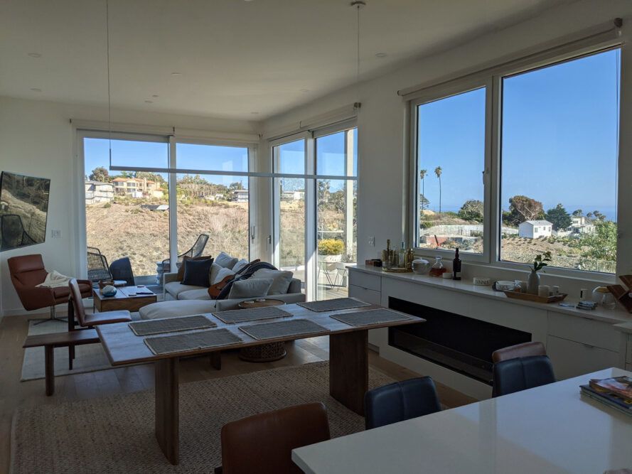 Large windows in a kitchen looking out on the coast.