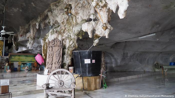 A water collection system in a limestone cave. Stalactites hang from the ceiling
