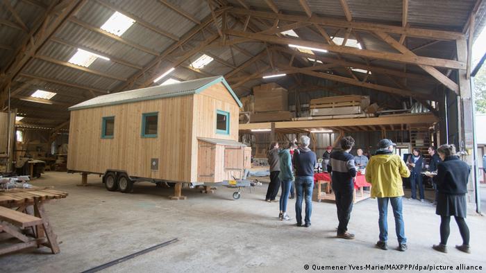 A tiny house in the production phase in a large workshop