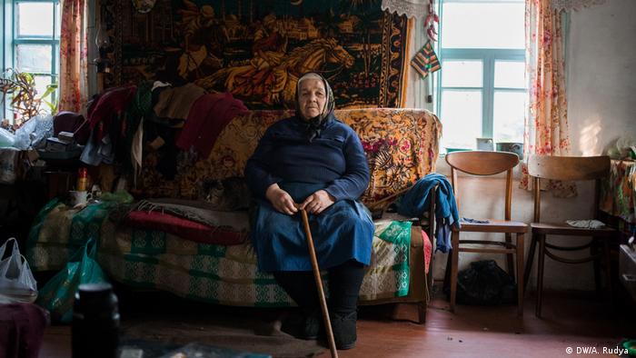 Galyna Ivanivna from Teremtsi, sitting in her house in the village in the exclusive zone of Chernobyl