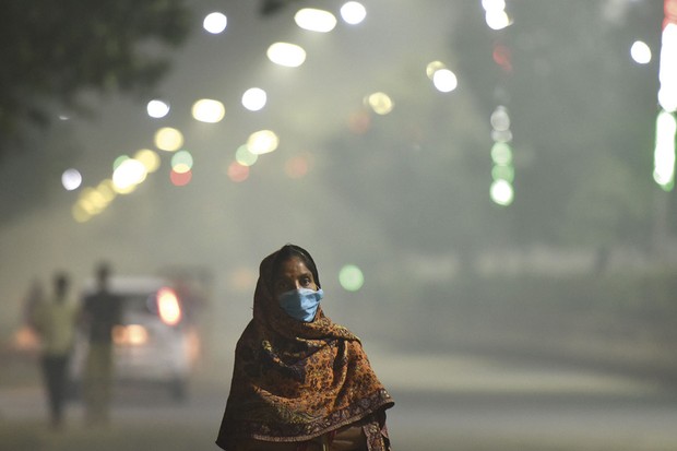 A person wearing a face mask in a smoggy street in Delhi  Getty Images
