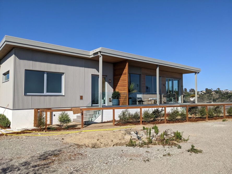 The exterior of a single-level home in a desert-like environment.