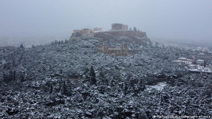The ancient Acropolis hill is covered with snow in Athens, Greece