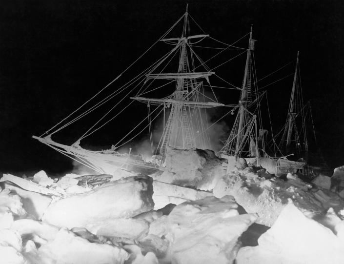 Shackleton's ship, the Endurance, as it lay locked in the Weddell Sea, where it finally sank, Antarctica, August 27, 1915. The remarkable lighting was furnished by an oil fire at the bow and a great deal of flash (gun) powder. / Credit: / Getty Images
