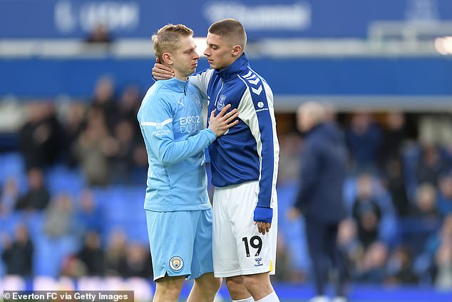 Zinchenko andMykolenko embrace before the kick-off as both discuss the tragic situation