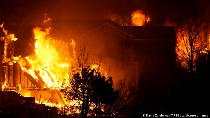 Homes burn as a wildfire rips through a development near Rock Creek Village