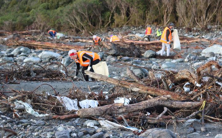 Volunteers pick up rubbish where a disused Fox River landfill spilled litter on the West Coast.