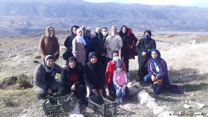 A group of women pose on a ridge for a group photo