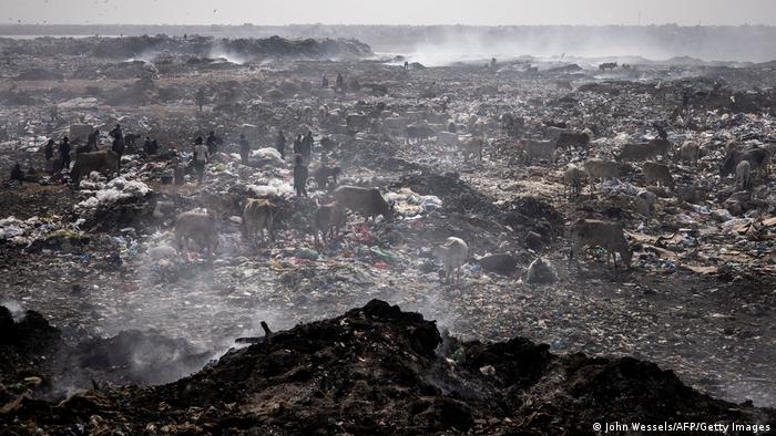 Waste pickers search of recyclable waste to sell in the Mbeubeuss rubbish dump in Dakar on July 14, 2021. 