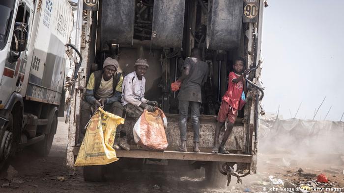 Young waste pickers catch a ride to the main rubbish mound in the Mbeubeuss rubbish dump in Dakar.