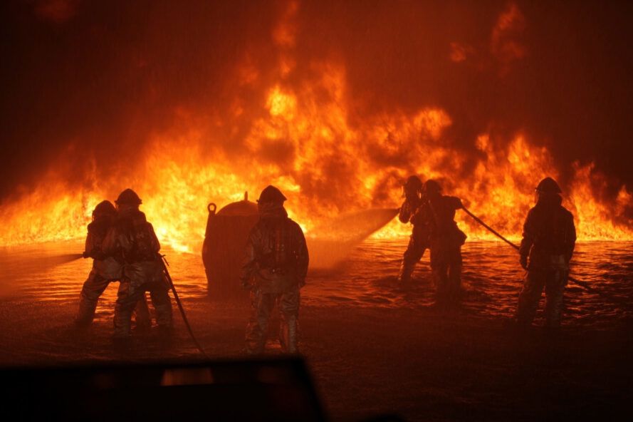 Firefighters in front of a fire.