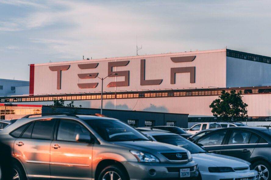 A Tesla parking lot full of cars.