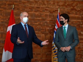 Prime Minister Justin Trudeau meets with B.C. Premier John Horgan during a break from the GLOBE Forum at the Convention Centre in Vancouver, B.C., on Tuesday, March 29, 2022.