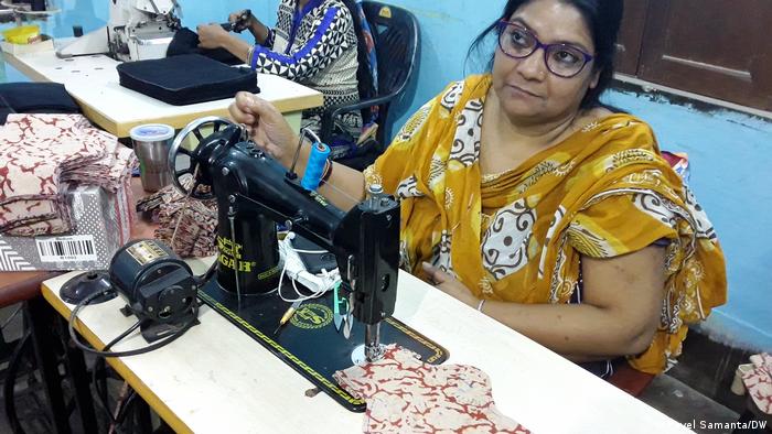 A woman at an old sewing machine 