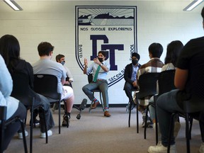Prime Minister Justin Trudeau is joined by Environment Minister Steven Guilbeault (left) and International Trade Minister Harjit Sajjan as they speak to students at David Thompson Secondary School, after Trudeau announced a federal climate plan at a Vancouver conference.