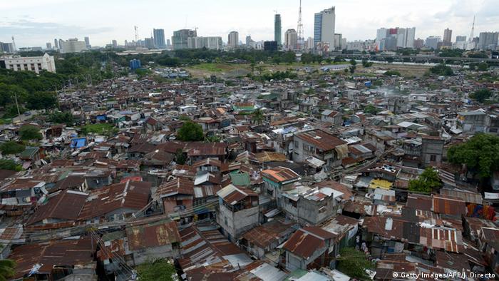 Slum dwellings with highrise skyline in the background