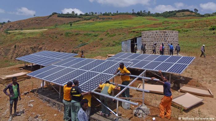 Near the village of Rema in Ethiopia, photovoltaic panels are mounted by a water tank to provide drinking water for the village