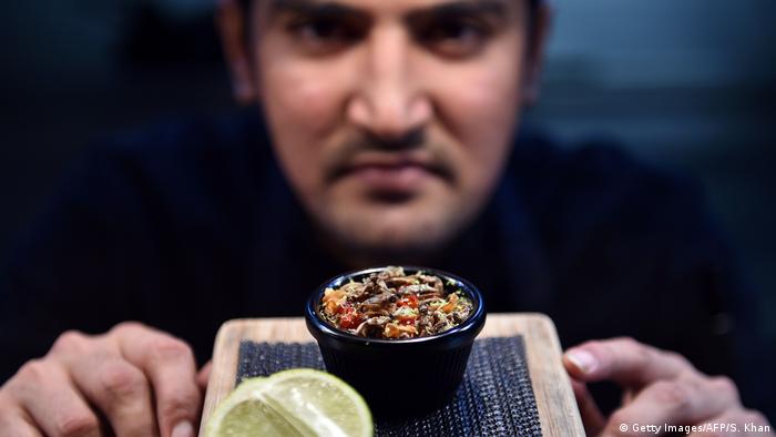 Sous-chef Nowshad Alam Rasel displaying a cricket dish