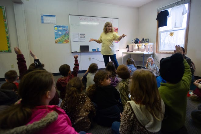 First-graders from Pauline Elementary School learn about the sun from Linnea Hoyos during one of many sessions taught Wednesday at the USD 437 Environmental Laboratory.