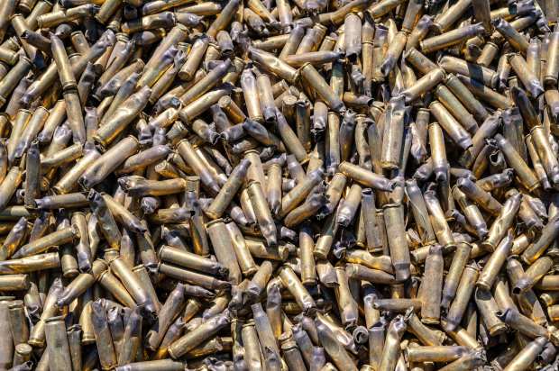 A dumpster full of empty brass shell casings at the...
