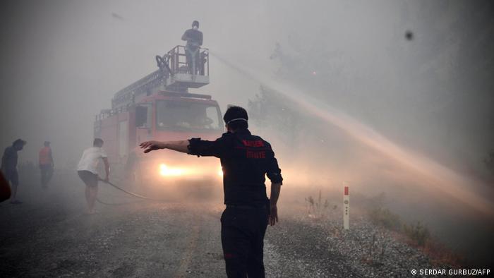 Firemen and local volunteers fight to extinguish a wildfire in Akcakoca, in the holiday region of Mugla, Turkey