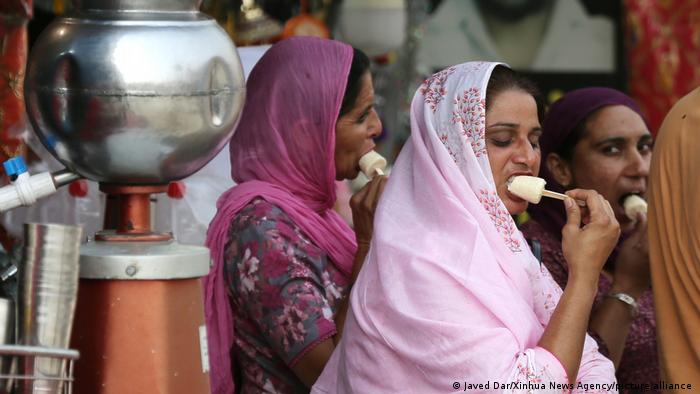 People enjoy roadside popsicles during a heat wave in Amritsar