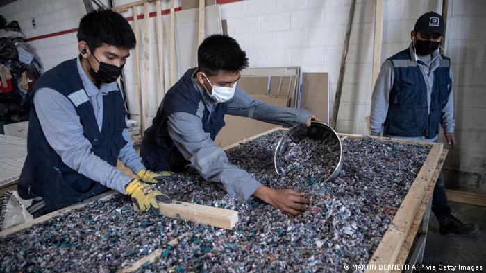 Men working at factory that recycles used clothes