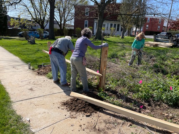 Kutztown Rotary Club partnered with Kutztown Thriving for the Rotary Day of Service project at the pollinator garden. Building a fence at the garden are John Galbraith and Charyn Ayoub with Connie Lawrence standing nearby. (Submitted photo)