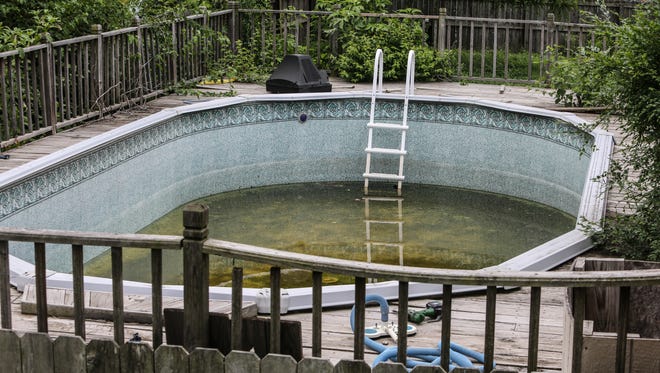 Abandoned pool, like this one seen Wednesday June 9th, 2014, at 3306 Chase Street, in the Frog Holler neighborhood, are a likely breeding group for mosquitoes. Experts recommend any sources of standing water be fully drained to help quell mosquito populations.