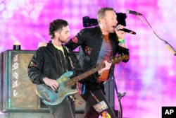 Guy Berryman, left, and Chris Martin of Coldplay performs during the band's Music of the Spheres world tour on Thursday, May 12, 2022, at State Farm Stadium in Glendale, Ariz. (Photo by Rick Scuteri/Invision/AP)